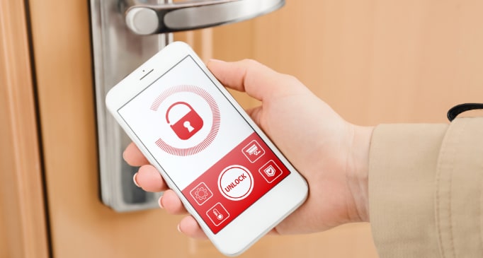 Person using smartphone security app to unlock door