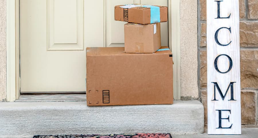 Boxes by the door of a residence with a welcome sign in Tampa